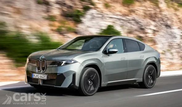 BMW iX4 front view on a road showing its sleek design