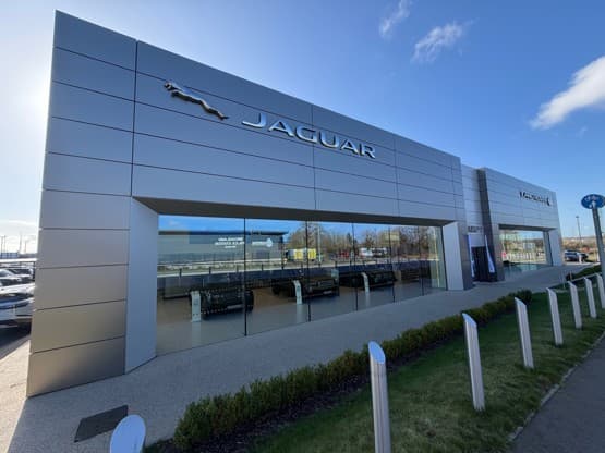 Who bought Jaguar Land Rover Norwich as Group 1 exits the UK market?