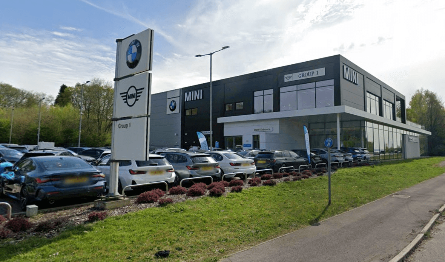 Group 1 Automotive UK showroom with new and used cars on display