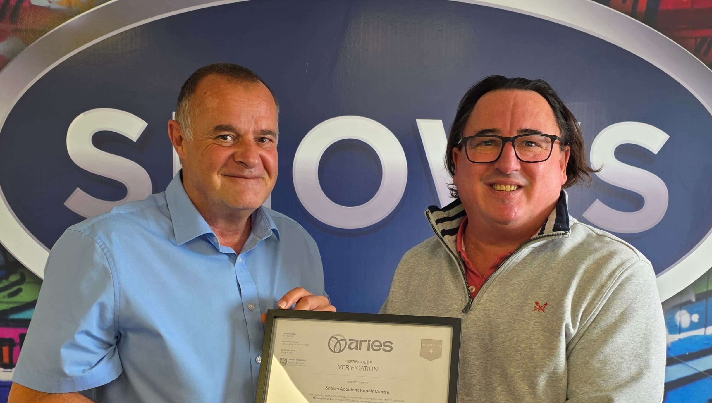 Dan Bush and Roy Edwards holding the Level 4 ARIES certificate at Snows Accident Repair Centre