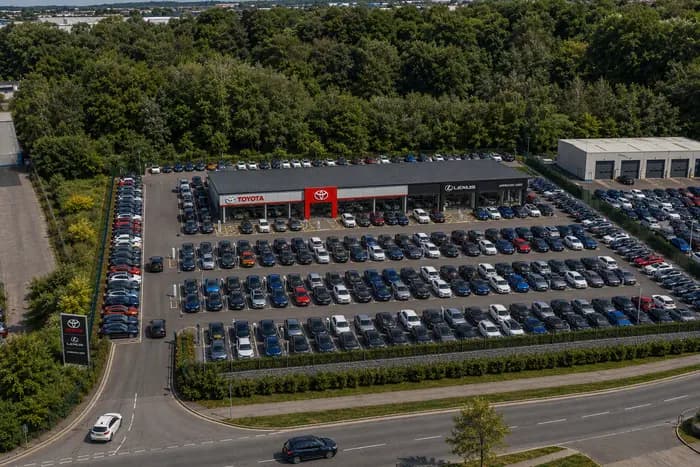 Construction site of the new Toyota and Lexus dealership in Poole, shown with scaffolding and signage