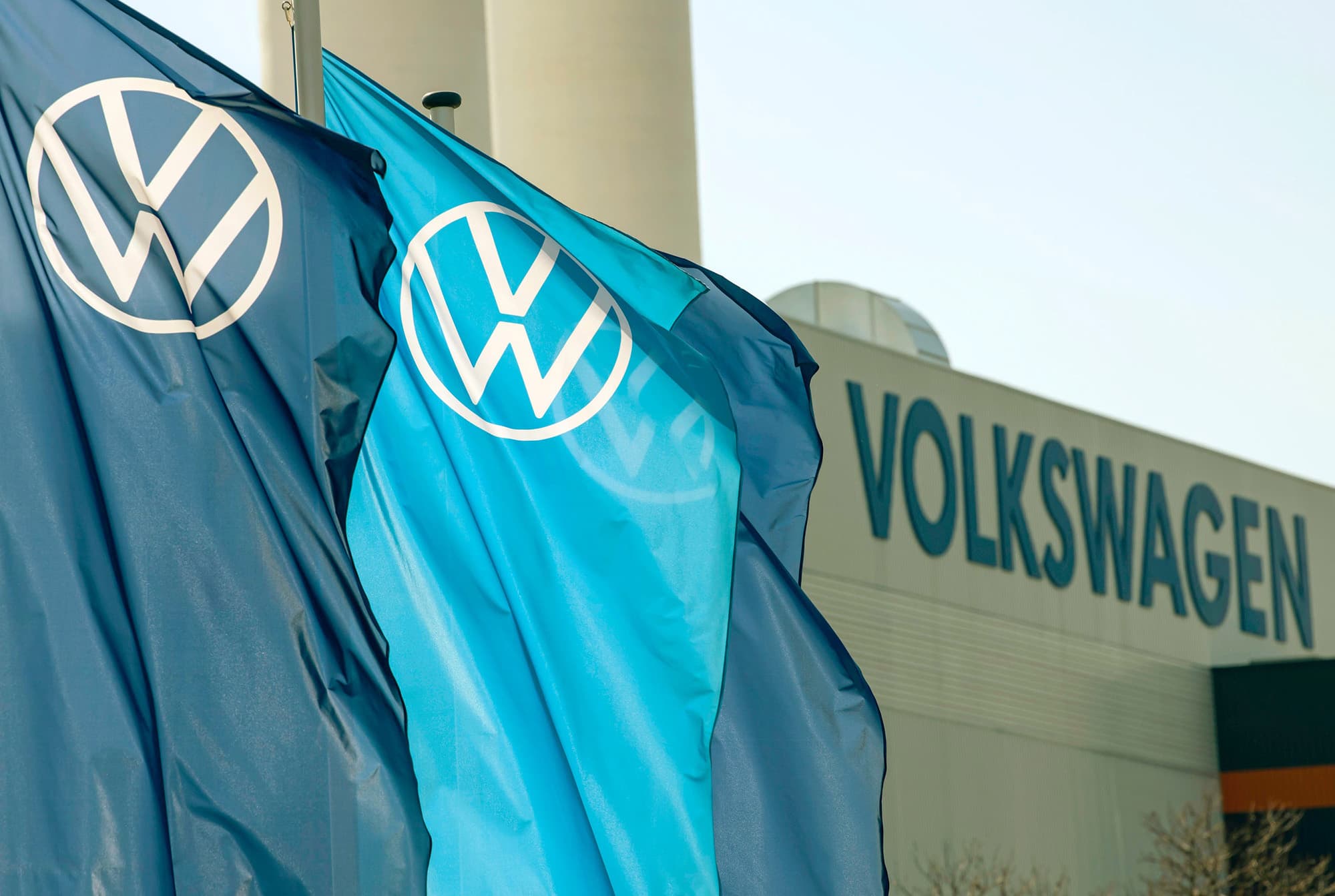 Volkswagen Group logo and factory background illustrating restructuring plans